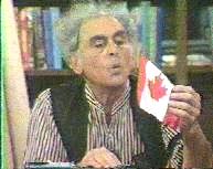 The Professor blows on a Canada flag.